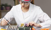 front-view-female-technician-with-soldering-iron-electronics-board