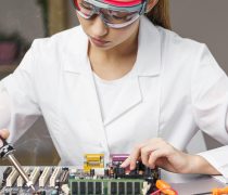 front-view-female-technician-with-soldering-iron-electronics-board